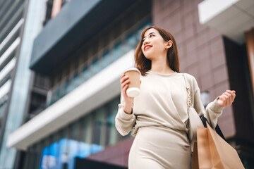 Single adult business asian woman confidence smiling holding coffee cup and shopping bag city...
