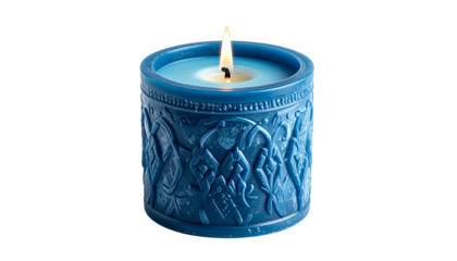 A lit blue candle in a cylindrical holder with detailed relief carvings, isolated on black