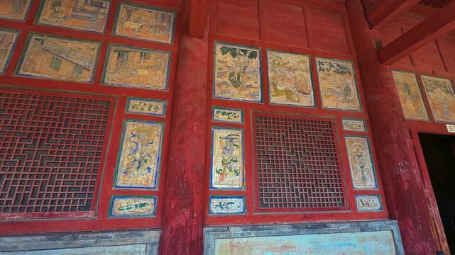 Intricate Carvings And Paintings Within The Mogao Caves Near Dunhuang In Gansu Province, China. Low Angle Panning Shot