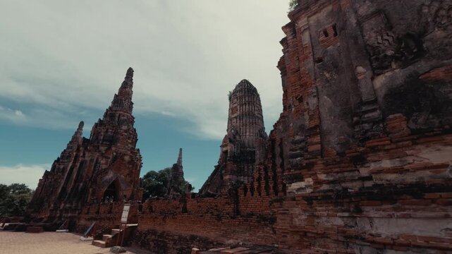 Wide shot of the ancient brick towers and walls of Wat Chaiwatthanaram temple ruins in Ayothaya, Thailand.