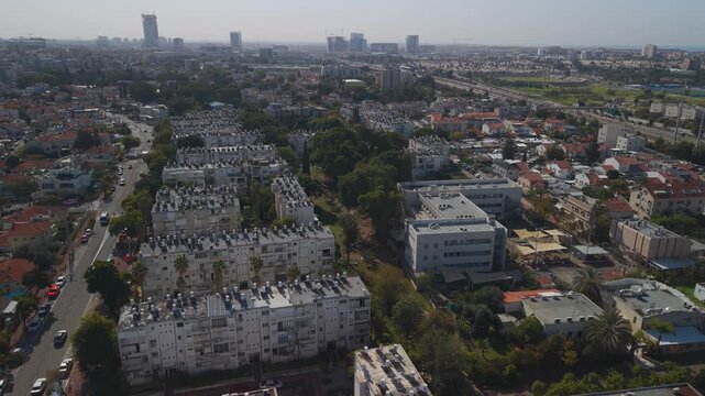 Jessi Cohen holon neighborhood overhead shot revealing compact housing architecture with distinctive red roofs in Israeli metropolitan area