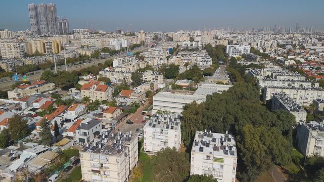 Urban Holon cityscape from above capturing typical residential neighborhood layout with rows of apartments and red tiled roofing system