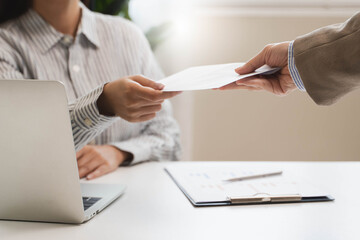 female employee smiling when she receive salary from boss.