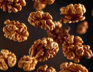 A close-up photo of several brown walnuts against a dark background