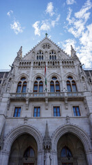 Fototapeta premium Entrance to the ornate neo-gothic Hungarian Parliament building. Located on the banks of the Danube River, in the center of Budapest