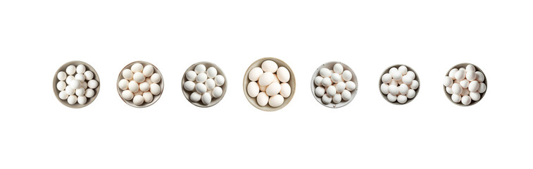 Variety of small white objects in metal containers on white background
