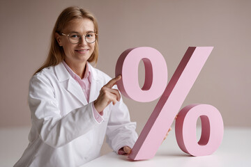 Woman in Lab Coat Holds Percentage Sign