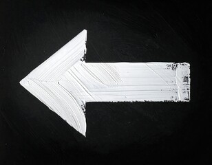 White paint brushstroke arrow pointing left, on a stark black background