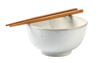 Porcelain bowl with wooden chopsticks resting on the rim, isolated on black