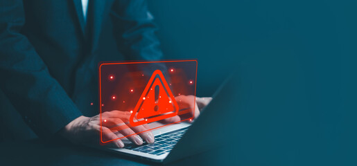 Cyber security alert concept with warning sign on laptop screen, representing data breach, hacking risk, malware detection, online protection, network security, information safety.