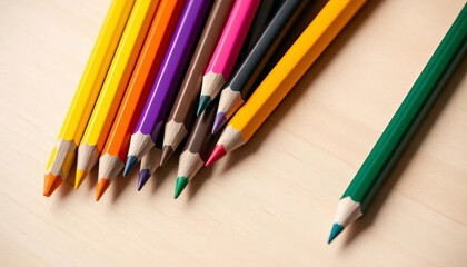 Obraz premium Vibrant colored pencils arranged artfully on a wooden table, drawing tools, creative tools
