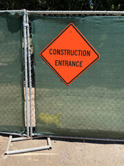 CONSTRUCTION ENTRANCE sign on a temporary fence