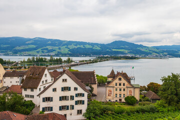 Fototapeta premium View of the old town, the Lake Zurich and mountains from the walls of Rapperswil Castle in Rapperswil-Jona, Switzerland