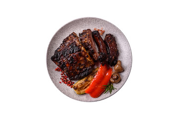 Grilled or barbecued pork or beef ribs, meat with red sauce for the dinner table. Grilled ribs