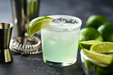 Classic lime margarita cocktail. Margarita cocktail on dark stone table, selective focus.