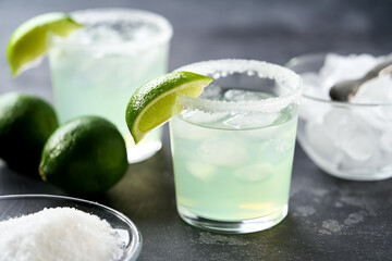 Classic lime margarita cocktail. Margarita cocktail on dark stone table, selective focus.