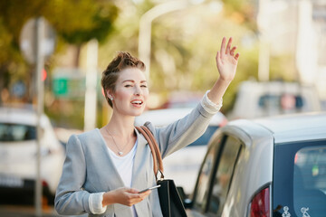 Businesswoman, phone and wave in city with taxi hailing for morning commute, transport and travel to job. Female person, outdoor and tech in urban town with raised hand, call cab and journey to work.