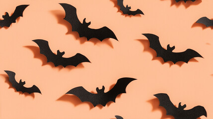 Obraz premium Flat Lay Of Black Paper Bats Arranged On Pastel Orange Background For Halloween Decor