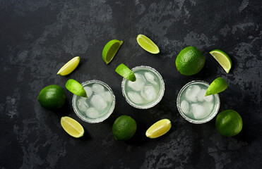 Margarita cocktail with lime and ice cubes, top view.