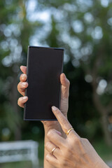 Young woman modern attire hand pointing using finger blank screen mobile phone Online work professional technology information digital office businessman computer using social media pro photo image.