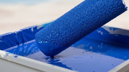 Paint Roller Applying Blue Paint to a Surface from a Tray, Captured from a Close-Up Viewpoint