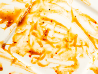 Dirty plate top view background, finished eat dinner in restautant, abstract textuer stain smearing drip sauce bbq jam chilli jelly on ceramic breakfast, concept for clean hyginene product.
