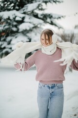Woman embracing winter joy in fresh snow