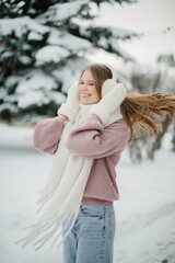 Young woman enjoying cold winter day smiling, hair flowing
