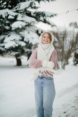 Young woman smiling enjoying cold winter season outdoors