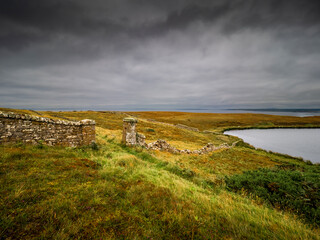 Caithness moorland with stone wall leading to tranquil loch