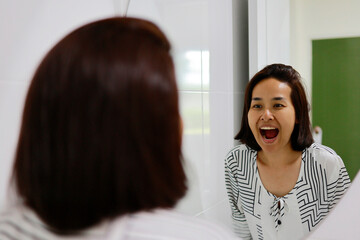 Woman washes her face in the morning with facial foam.