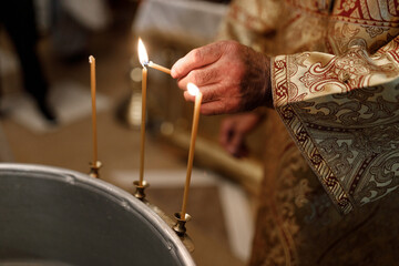 Orthodox Priest Lighting Candle During Child Baptism