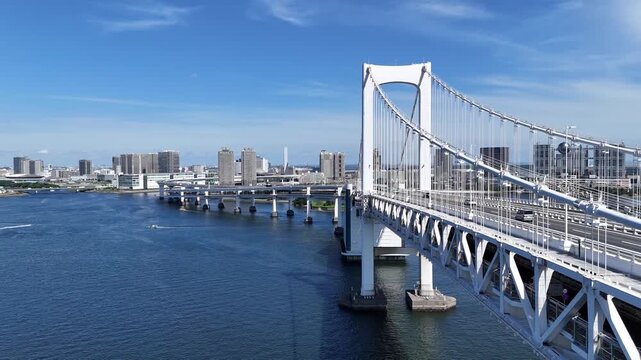 Rainbow Bridge spanning Tokyo Bay with Odaiba high-rise buildings in background 