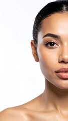Half portrait of a woman with smooth skin and minimal makeup, against stark white background
