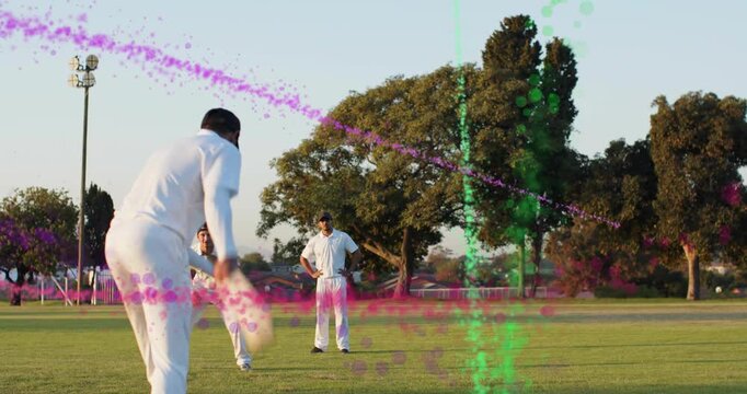 Sports bowler releasing, batsman aiming shot while CGI trails tracing path, fielder collecting ball
