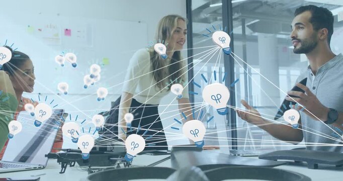 Animation of network of bulb icons over group of diverse colleagues discussing together at office