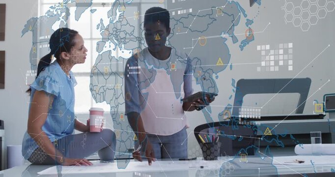 Animation of world map and data processing against two diverse woman discussing at office