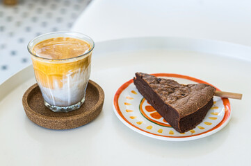 A cup of latte Chocolate brownie in coffee shop