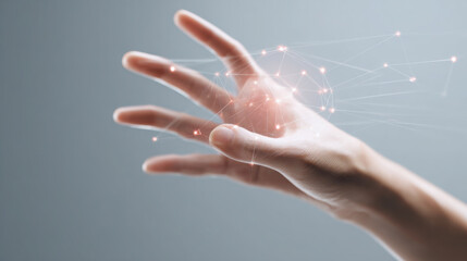A human hand reaches out to interact with a glowing digital network of connected nodes and lines on a gray studio background interface.