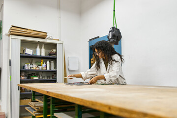 Woman working in art studio creating mosaic art