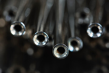 Steel rods, mounting and structural elements, reflecting light in an industrial environment,...