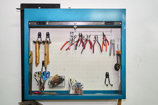 Workshop pegboard organizing various hand tools