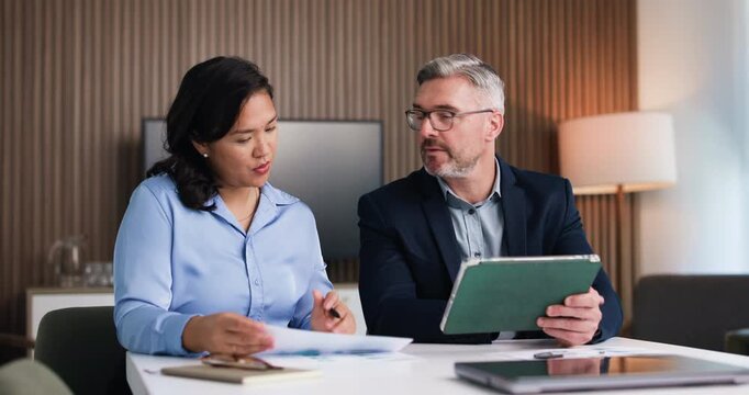 Business people, tablet and planning with team at office, review and happy at insurance company. Mature man, woman and tech with app, charts or documents with collaboration at risk management agency