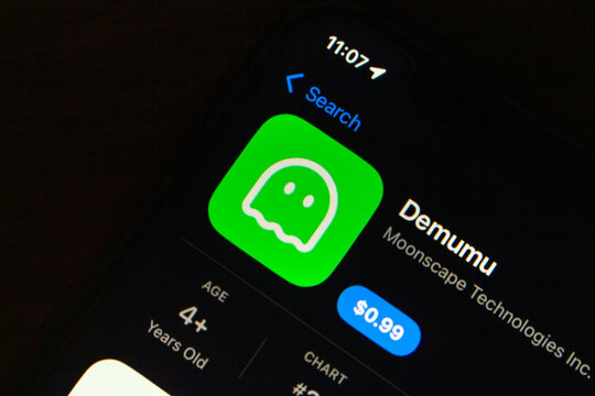 Quito, ECUADOR - Jan 13 2026 : Close-up of a smartphone screen showing the Demumu game app listing in the App Store with price and age rating.