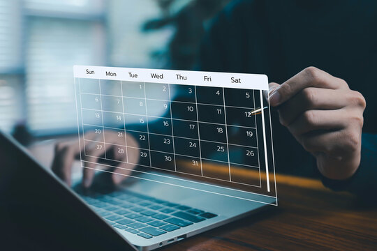 Business professional pointing at digital calendar on laptop screen, representing schedule planning, deadline management, appointment setting, time organization, productivity control, and business. - Powered by Adobe