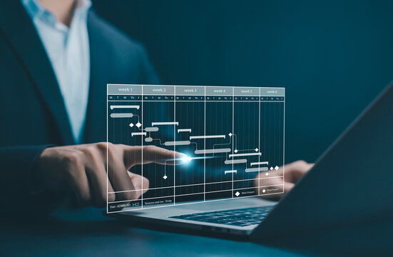 Business professional interacting with digital Gantt chart on laptop, representing project management, timeline control, task scheduling, workflow optimization, progress and business productivity. - Powered by Adobe