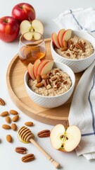 Apples and Oats Delight: A wholesome breakfast scene featuring two bowls of creamy oatmeal, adorned with fresh apple slices, crunchy pecans, and a drizzle of honey.