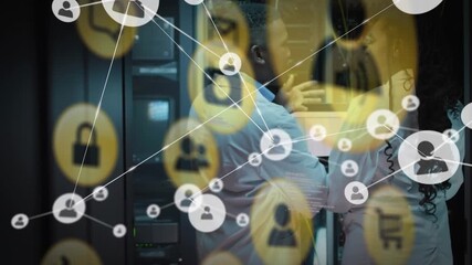 African american computer technicians are using laptop computers in a business server room - Powered by Adobe