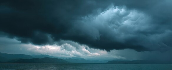 Gloomy thunderclouds roll in on the horizon hinting at natureos brewing energy