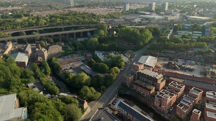 Newcastle upon Tyne: 9th August 2025: Byker Bridge spans Ouseburn Valley in bustling city and green areas surrounding at dawn